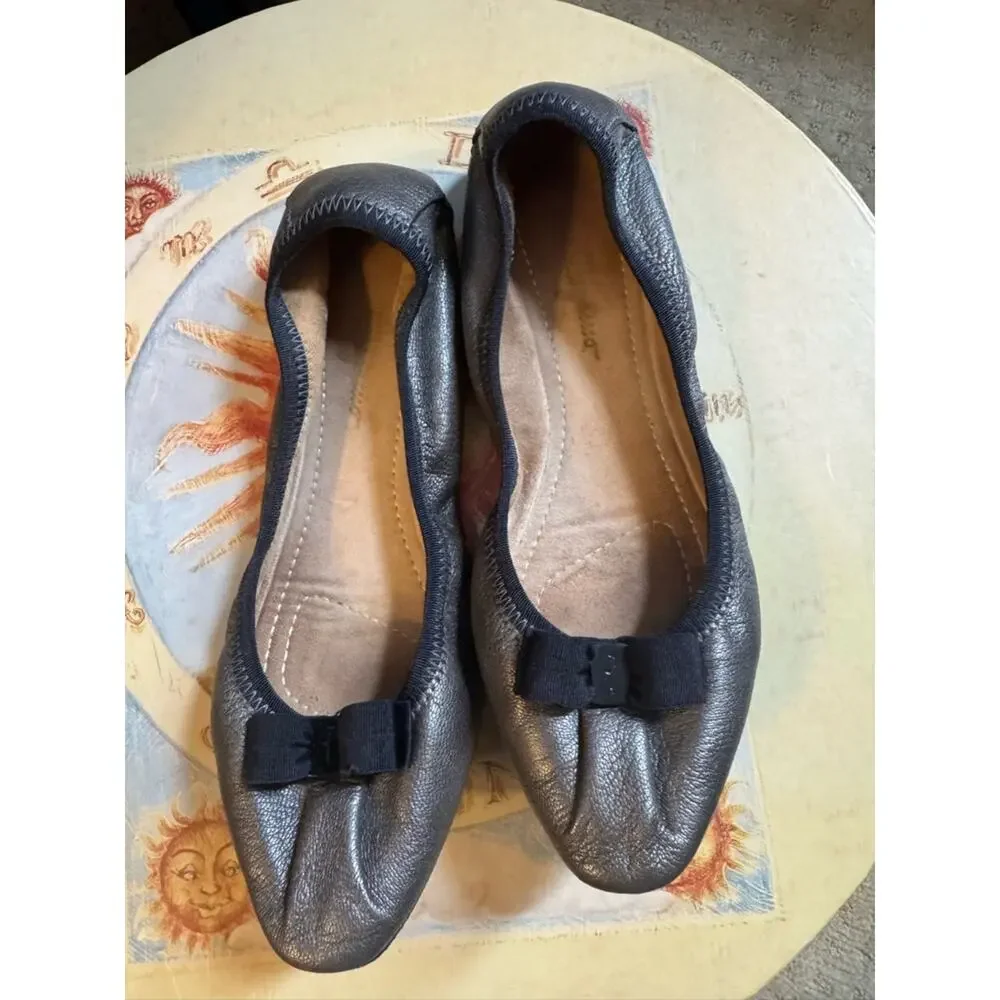 Salvatore Ferragamo Metallic Black Leather Bow Ballet  flats the color is bronze